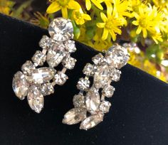 "Vintage D&E Juliana silver tone metal clip on earrings with clear glass crystals  Not singed Measures 11/4 \"x 1/2\" In  good vintage condition. Some light wear from age. Please keep mind each electronic device has different resolution, brightness and clarity. Therefore products might have slight difference of shade/tone/color in person. Please see my other listings and thanks for shopping." Vintage Silver Crystal Earrings For Wedding, Silver Crystal Clip-on Earrings For Formal Events, Costume Jewelry Earrings With Rhinestones For Wedding, Costume Jewelry Wedding Earrings With Rhinestones, Clip-on Costume Jewelry Earrings For Wedding, Vintage Clip-on Crystal Earrings For Wedding, Vintage Crystal Clip-on Earrings For Wedding, Silver Costume Jewelry Clip-on Earrings For Wedding, Silver Clip-on Earrings For Formal Costume Jewelry