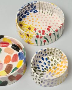 three bowls with different designs on them