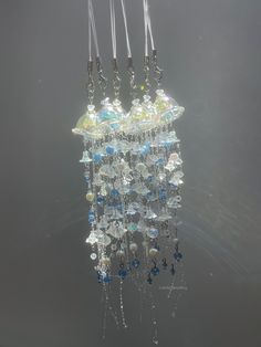 a chandelier hanging from the ceiling in front of a gray wall and floor