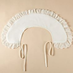 a white head piece with crochet trim and two pairs of scissors attached to it