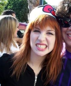 two people are posing for the camera with one woman's head in her hair