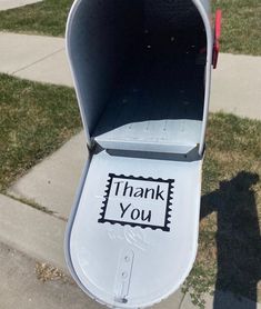 a mailbox with the word thank you written on it and an envelope in the back