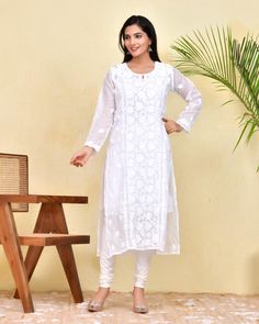 Our White Chikankari Kotadoria Straight Kurta is crafted from high-quality cotton for superior comfort and fit. It features a relaxed fit that's perfect for everyday wear. Experience the utmost comfort without compromising an elegant style! Features: Long kurta in Pure soft Kotadoria cotton fabric Hand-embroidered with Chikankari  work Our model is wearing size S and is 5 feet 6 inches tall. Length: Kurta - 47" inches |  Fabric: Pure Soft Cotton Embroidery : Chikankari ghasspatti work Color: White Print : Floral Print Matching White Pant or sharara is avl Inner or white Cotton Slip is avl. Pls message if you required. Garment-Care We recommend to dry clean only. Do not soak and scrub the product and dry it in shade. Do not iron on embellishments. Unstitched Long Sleeve Cutwork Kurta, Long Sleeve Kurta With Cutwork For Eid, Anarkali Long Sleeve Kurta With Cutwork, Anarkali Kurta With Long Sleeves And Cutwork, Anarkali Kurta With Cutwork And Long Sleeves, Eid Cutwork Straight Kurta, Festive Long Sleeve Kurta With Cutwork, Eid Long Kurta With Chikankari Embroidery, Traditional Long Sleeve Cutwork Wear For Diwali