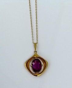 "A beautiful vintage gold pendant and gold chain. The superb pendent stone is a medium purple hue colour and is displayed wonderfully within the beautifully designed solid gold decorative setting. A really lovely piece for a special occasion, someone special or to add to your collection. ▪ Overall Condition: Excellent ▪ Metal: Pendant 9ct Gold ▪ Metal: Chain 9ct Gold ▪ Gem: Paste Stone ▪ Colour: Purple ▪ Gem Cut: Oval Cut ▪ Gem Colour: Purple ▪ Insurance Estimate: £935 ▪ Marked: \"London\" &  \"9ct\" ▪ Weight: 6.3gms ▪ Payment Layaway Plan Available: Yes ▪ Full Detailed Appraisal: Quotation Available As a qualified Gemmologist and Jeweller with over 20 years experience in the jewellery  industry, each jewel is chosen for its  'quality, beauty and interest'... As a Consultant in a contempor Vintage Birthstone Necklace For Formal Occasions, Vintage Pendant Necklace With Birthstone, Vintage Birthstone Pendant Necklace, Antique Gold Necklace With Birthstone, Vintage Yellow Gold Birthstone Necklace, Vintage Purple Oval Pendant Necklace, Vintage Purple Round Pendant Necklace, Purple Art Deco Necklace For Gift, Vintage Gold Pendant