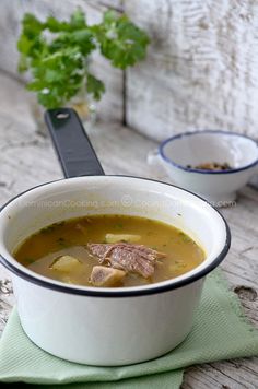 a bowl of soup with meat in it