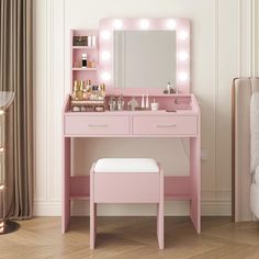 a pink vanity with lights on it and a stool in front of the mirror that is lit up