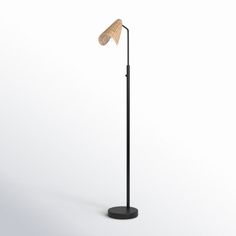 a floor lamp with a wooden shade on it's head and an iron base