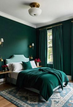 a bedroom with dark green walls and white bedding