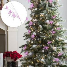 a decorated christmas tree with pink and white ornaments on it next to a potted poinsettia