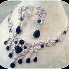 This Breathtaking Blue Sapphire Bridal Necklace And Earring Set Will Add Red Carpet Glamor To Your Wedding Ensemble. This Lavish Jewelry Set Is For The Bride Who Loves Attention Getting, Head-Turning Bling In A Luxury Design! This Necklace Set Is Very Sparkly And Unique! You Are Sure To Be Noticed With This Set. Craftsmanship And Durability Like This Are Not To Be Confused With Cheap Jewelry.Metal Type: High Quality Electric Gold Filled 5 Micron Layer Exquisite Blue Teardrop Jewelry, Heart-shaped Wedding Jewelry With Jewels, Luxury Blue Jeweled Jewelry, Heart Shaped Wedding Jewelry, Heart-shaped Wedding Jewelry, Blue Sterling Silver Embellished Jewelry, Blue Sterling Silver Jewelry With Jewels, Elegant Blue Hand Set Earrings, Blue Crystal Jewelry Set For Anniversary