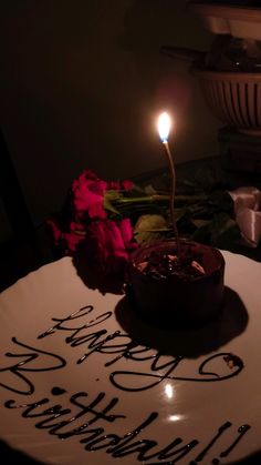 a birthday cake with a lit candle on it