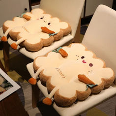 two white chairs with stuffed animals on them