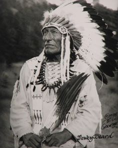 an old black and white photo of a native american man