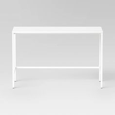 a white table sitting on top of a white floor