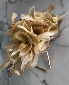 A striking large light gold coloured Fascinator. A gorgeous full flowing design, with shimmering folds of material delicately centred on a gold base. Finished by delicate feather detailing in the same shade makes this Fascinator hat a beautiful addition to any outfit. This piece sits firmly on the head with a co-ordinating satin covered headband. Fascinator measures approx 30cm. Our timeless pieces are perfect for any special occasion from Weddings to The Kentucky Derby and Summer Garden Parties! We offer ready to wear pieces in a variety of styles and colour! However if you want to make your piece unique, we can customise any piece with additional feathers and make it your own! Similarly most fascinators can be created on a comb, headband or clip, whichever you would prefer! If you're loo Derby Wedding, Headband Fascinator, Hat Wedding, Light Gold Color, Summer Garden Party, Wedding Hat, Wedding Fascinators, Feather Fascinators, Fascinator Hat