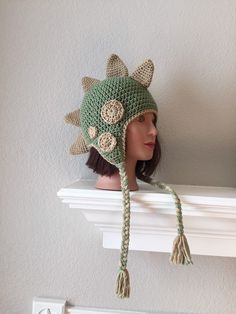 a crocheted hat on top of a white shelf