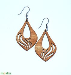 the wooden earrings are made from wood and have an intricate design on each earring