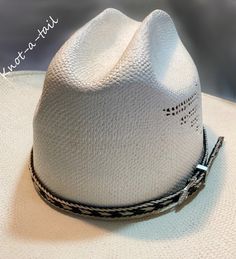 This horsehair hat band is    IMPRESSIVE!  EXTREMELY BOLD  The outside is done in a creamy white rich  BLACK horsehair inside  with creamy white trim With a 3 piece buckle set-  fancy Southwest design.  Unique, distinctive and exceptional quality. Everything you want in a Horsehair hat band. because this one brings out your spirit in an exclusive design that is vibrant as your western  lifestyle.             MEASUREMENTS * Longest length 25 inches * Shortest length about 15 inches or less if nee White Panama Hat With Short Brim For Rodeo, White Western Panama Hat With Curved Brim, White Western Panama Hat With Short Brim, White Short Brim Panama Hat For Rodeo, White Western Fedora Panama Hat, White Western Straw Hat With Short Brim, White Western Style Straw Hat With Short Brim, White Straw Hat With Short Brim For Ranch, White Brimmed Panama Hat For Rodeo