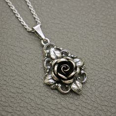 This elegant TEKA Theodor Klotz sterling silver pendant features a beautiful rose flower design, showcasing the exquisite craftsmanship of mid-century German designer jewelry. The famous rose design by TEKA (TEKA studio in Pforzheim, Germany, founded by Theodor Klotz). This vintage piece is a timeless accessory that can be purchased on its own or with an optional 20" sterling silver rope chain, adding versatility and charm to your jewelry collection. The pendant will be shipped in a gift box, ma Rose Flower Design, Vintage Sterling Silver Jewelry, Belle Rose, Mid Century Vintage, Timeless Accessories, Beautiful Rose, Rose Design, Schmuck Design, Rope Chain