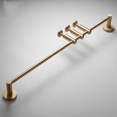 an image of a gold towel rack with four bars on each side and two hooks in the middle