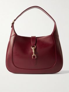 Gucci's small 'Jackie' bag takes its curved silhouette from the original style that debuted in the '60s and even boasts the same gold-tone piston clasp. Crafted in Italy from burgundy leather, it's suspended on a thick strap that can be adjusted to your perfect drop. It has plenty of space inside for everyday essentials, like your wallet, keys, cell and compact. Group Discussion Topics, Shojo Girl, Gucci Clothing, Group Discussion, Red Shoulder Bag, Sacs Design, Designer Shoulder Bag, Discussion Topics, Technology Fashion