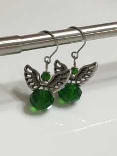 "Small angel earrings 1.25\" From hook to bottom, it dangle 1\" long, 8x10mm emerald green faceted crystal glass silver metals wings nickel and lead free, stainless steel fish hook Hand made jewelry. All purchase will arrive in gifts boxes. Thanks for stopping by!" Green Dangle Crystal Earrings, Green Crystal Earrings For Jewelry Making, Green Christmas Drop Earrings Jewelry, Green Faceted Sterling Silver Earrings, Silver Earrings For Party With May Birthstone, Green Dangle Crystal Earrings For Gift, Nickel-free Green Sterling Silver Crystal Earrings, Nickel-free Green Crystal Earrings In Sterling Silver, Green Sterling Silver Crystal Earrings