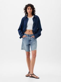 Fit: Cut loose through the hip and thigh with a longer leg.  Fabric: 95% Cotton, 5% Recycled Materials.  Stretch: Low Stretch Shorts.  Authentic denim with a soft & easy lived-in feel. ​ Rise: Mid Rise Denim Shorts.  Look: A classic five-pocket bermuda short in a medium indigo wash.  Details: Zip fly & five-pocket styling.  Responsibly Made: This pair of jeans is part of our water-saving Washwell program.  Compared to conventional wash methods, Washwell has saved millions of liters of water sinc Long Denim Shorts Outfit, Long Denim Shorts, Denim Shorts Outfit, Mid Rise Denim Shorts, Bermuda Short, Double Denim, Embellished Blouse, Mid Rise Shorts, Shorts Outfit