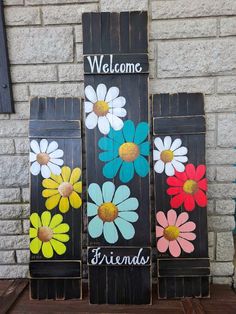 three wooden signs with flowers painted on them