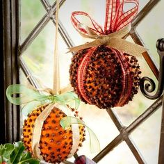 two ornaments hanging from the side of a window