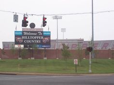 a large billboard on the side of a road in front of a red traffic light