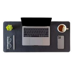 a laptop computer sitting on top of a desk next to a cup of coffee and eyeglasses