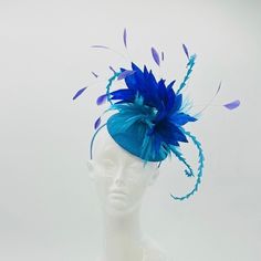 Handmade by Featured Milliner of The Kentucky Derby Museum 2023 & 2024! Beautiful shades of blue feathers on a button base.  Attaches with headband.  Not taking customs this year--Derby 150 is going to be massive and mom life keeps me running! However, happy to suggest pieces that will coordinate with your outfit. If you don't love the way this attaches to your head--message me!  I can swtich *most* pieces to your preference. Clip, Headband OR Elastic Cord  NOTE: Heavier pieces with extravagant Head Message, Clip Headband, Kentucky Derby Fascinator, Blue Feathers, Derby Fascinator, Head Wear, Kentucky Derby Hat, Derby Hat, Blue Feather