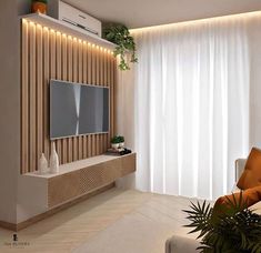 a modern living room with white curtains and wood paneling on the wall, along with a flat screen tv