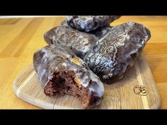 chocolate donuts with icing on a cutting board