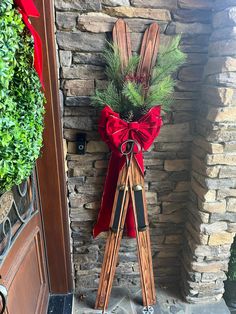 a door with a red bow and wooden skis on it