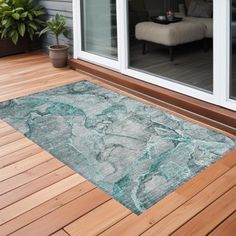 an outdoor area rug with wood flooring and sliding glass doors leading to the outside