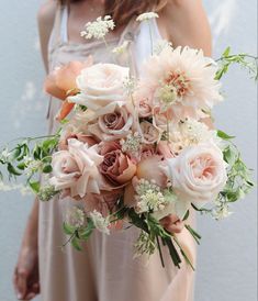 a woman holding a bouquet of flowers in her hands