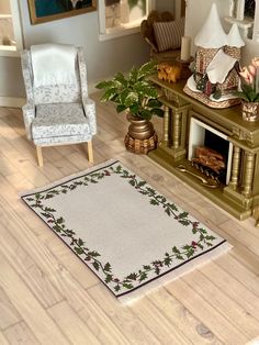 a living room filled with furniture and a rug on top of a hard wood floor