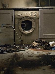 an old washer and dryer in a dirty room