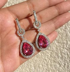 Pink earrings featuring semi precious pink stone and cz diamonds in drop shape. Ideal jewelry to pair with your bridal wedding gown or any special occasion outfit. These LUXURY Earrings surely elevate your look. Perfect gift for her. *𝐏𝐑𝐎𝐃𝐔𝐂𝐓 𝐃𝐄𝐓𝐀𝐈𝐋* * 𝐌𝐚𝐭𝐞𝐫𝐢𝐚𝐥: Brass * 𝐏𝐥𝐚𝐭𝐢𝐧𝐠: White Rhodium Plated * 𝐒𝐭𝐨𝐧𝐞: AAA-quality CZ Diamond. *𝐃𝐈𝐌𝐄𝐍𝐒𝐈𝐎𝐍𝐒* * 𝐖𝐞𝐢𝐠𝐡𝐭: 6 gm each * 𝐋𝐞𝐧𝐠𝐭𝐡: 1.7 Inches * 𝐖𝐢𝐝𝐭𝐡:  0.6 Inches * 𝐂𝐥𝐨𝐬𝐮𝐫𝐞: Push Back 𝐕? Luxury Diamond Accent Earrings For Valentine's Day, Pink Diamond Earrings, Bride Wedding Gift, Pink Crystal Earrings, Occasion Outfit, Earrings Luxury, Wedding Gifts For Bride, Luxury Earrings, Special Occasion Outfits