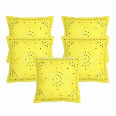 four yellow pillows with sequins on them