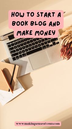 a laptop computer sitting on top of a desk next to a pine cone and notebook