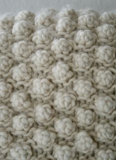 a close up view of some white crocheted material