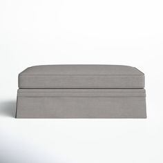 an upholstered footstool on a plain white background with room for text