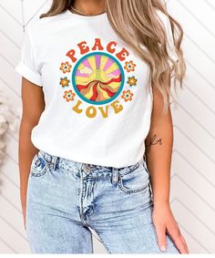 "Peace, Love Retro Tshirt! This shirt brings us back to a better time, a time when things were groovy and there was peace and love. Show the world that you support peace!  Light fabric, tear-away label, runs true to size - see size chart and color chart. HOW TO ORDER: 1) Please review all photos for size and color options before ordering. 2) Choose your shirt size and color. Please be aware that colors may differ slightly from their appearance on screen. 3) Click \"Add to cart\". PRODUCTION and SHIPPING Production and processing are generally 1-3 days with shipping between 2-7 business days (after processing and production time). CANCELLATION POLICY We are happy to accept cancellations within 1 hour of purchase. If later than one hour, please contact us to make sure we haven't started prod Retro White T-shirt With Funny Print, White Casual T-shirt With Retro Print, Casual White T-shirt With Retro Print, White Graphic Tee With Retro Print, Retro White Top With Custom Print, Groovy Summer T-shirt With Letter Print, White Retro T-shirt With Custom Print, Retro White T-shirt With Custom Print, Summer Crew Neck Top With Peace Sign