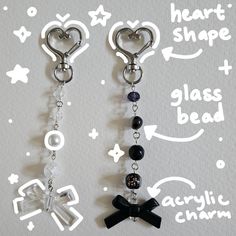 two black and white heart shaped earrings hanging from hooks on a gray background with the words clear bead written below them