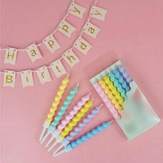 a bunch of candles sitting on top of a table next to a sign that says happy birthday