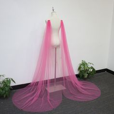 a mannequin with a pink veil on top of it