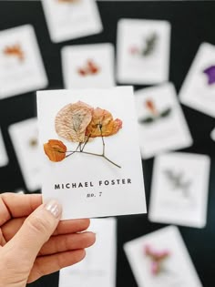 a person holding up a card with leaves on it and the words michael fosterer no 7