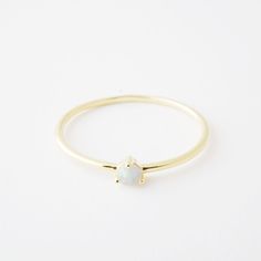 White Opal Birthstone Ring In Dainty Style, Dainty White Opal Birthstone Ring, White Opal Dainty Birthstone Ring, White Dainty Opal Birthstone Ring, Minimalist Opal Birthstone Ring, Gold Dainty Opal Ring Birthstone, Dainty Gold Opal Ring Birthstone, Classic Round Opal Ring, Adjustable Round Moonstone Ring In Minimalist Style